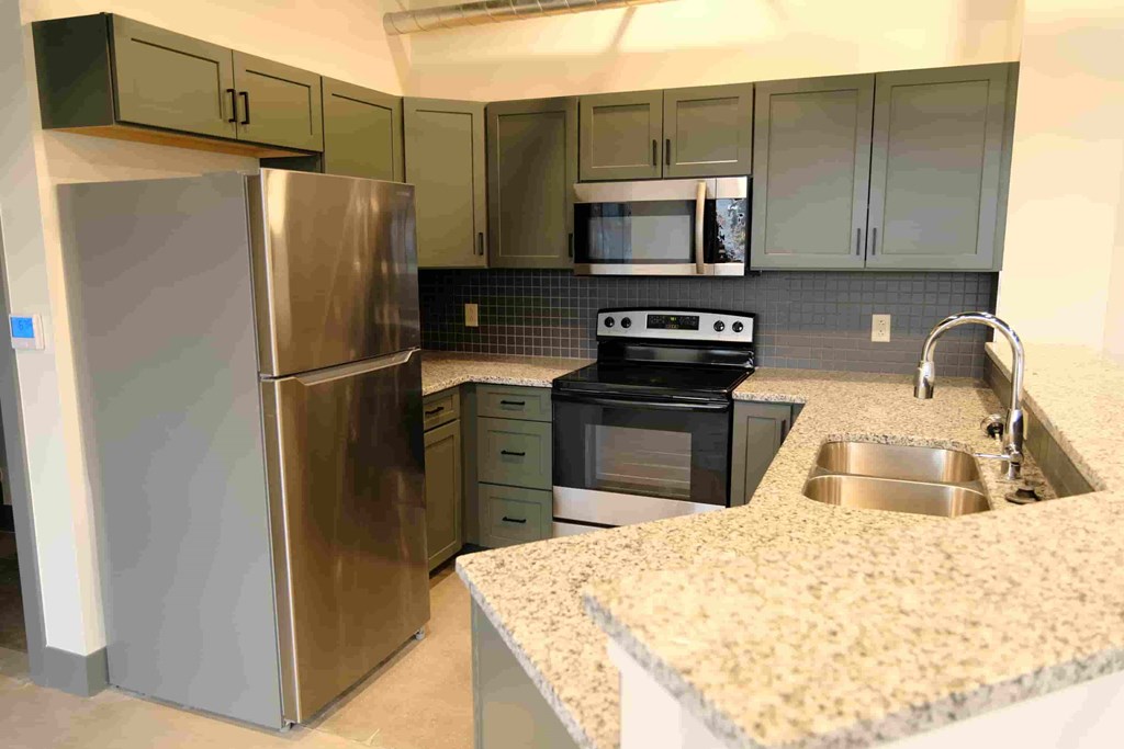 a kitchen with granite counter tops and stainless steel appliances