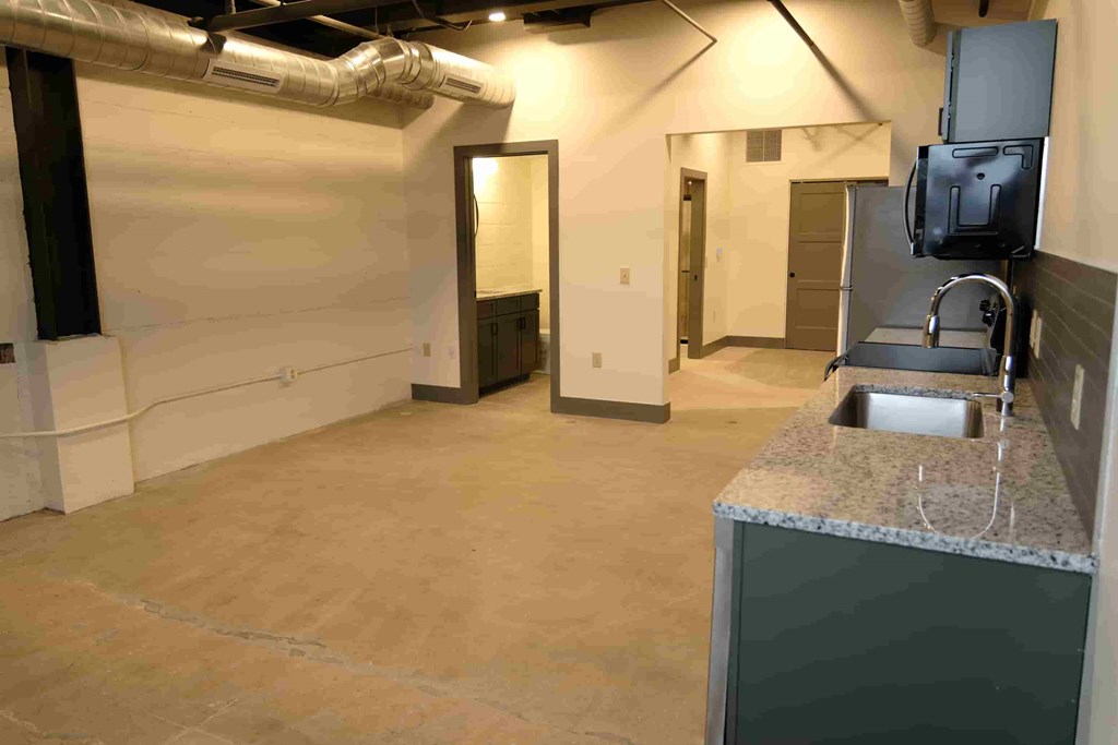 an empty room with a sink and a tv