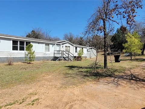 a white house with a yard in front of it