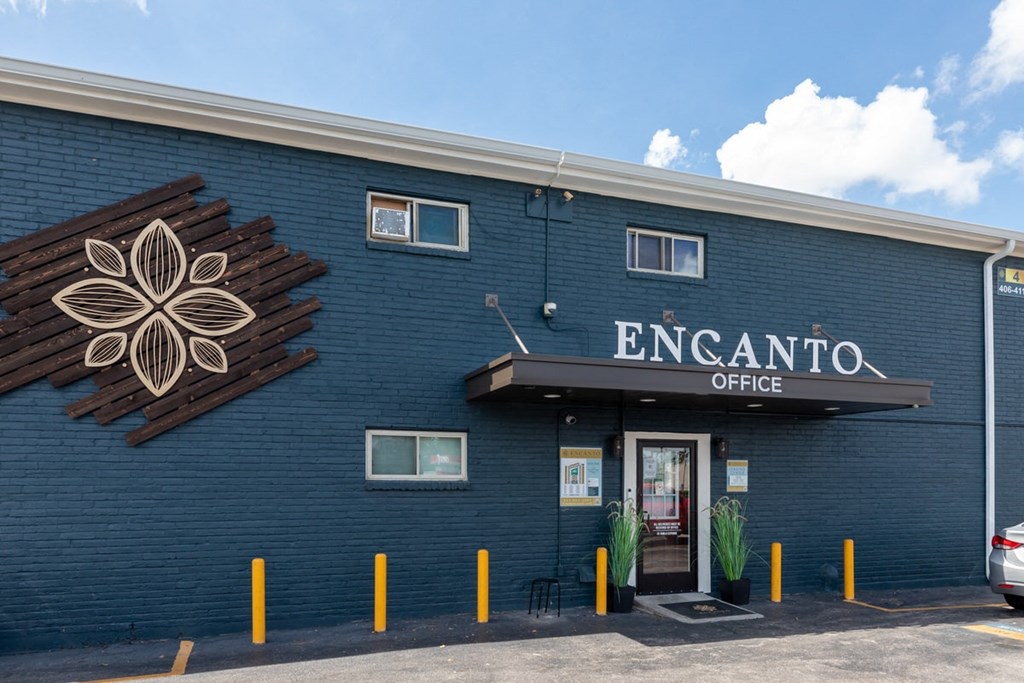 a blue building with a flower on the side of it