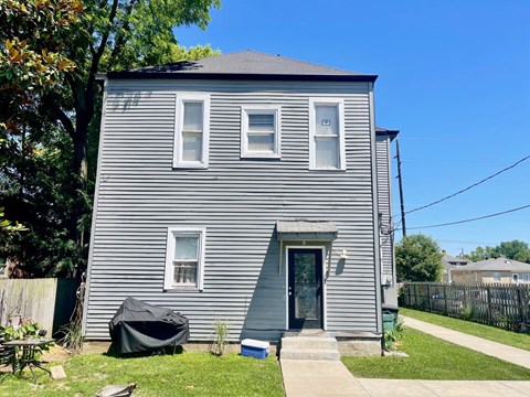 the front of a house with a yard and a sidewalk