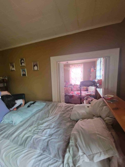 a bedroom with a bed and a door to a closet