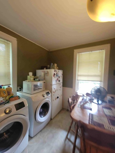 A laundry room with a washer and dryer stacked on top of each other.