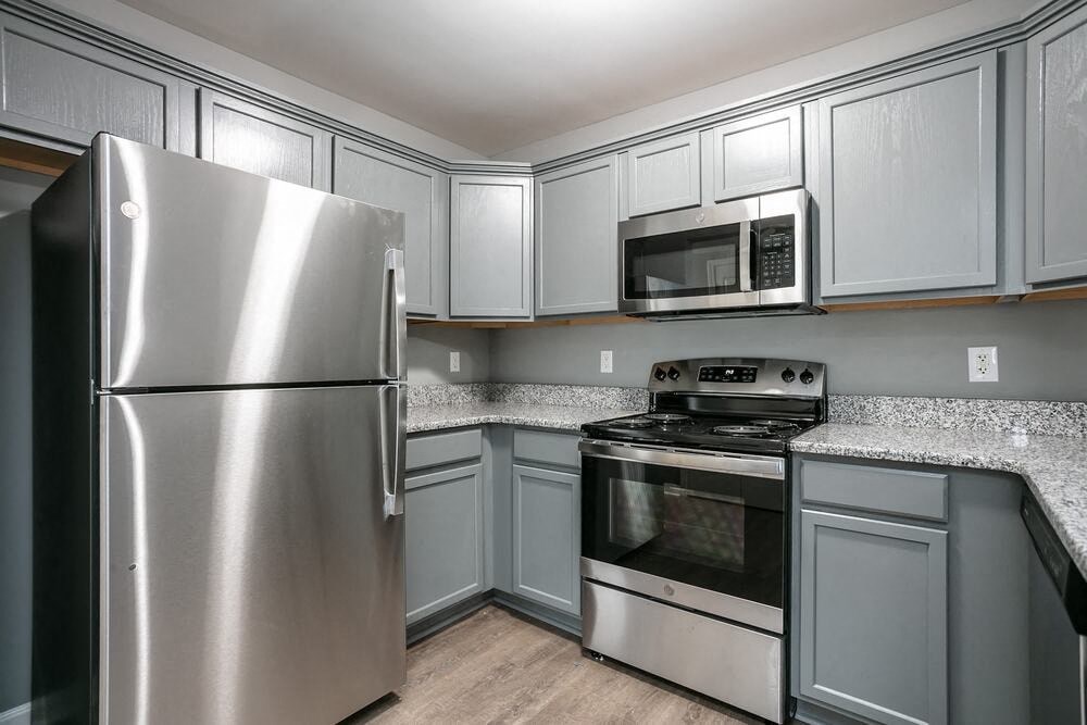A kitchen with a stainless steel refrigerator and oven.