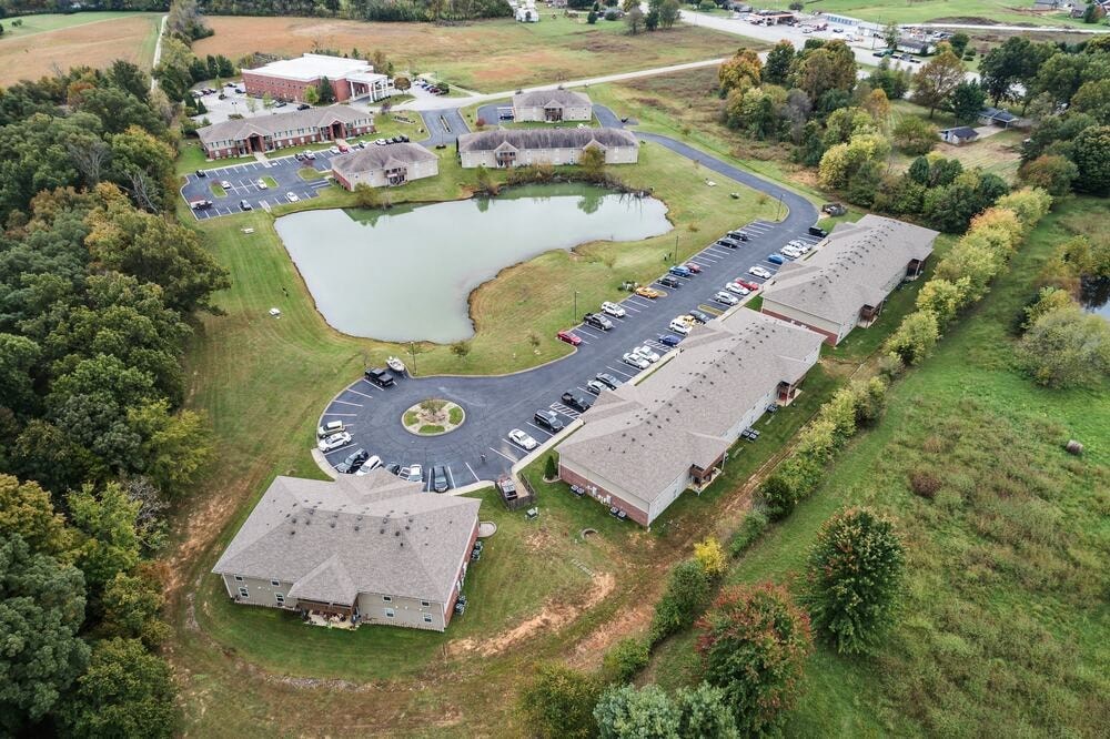 A large building complex with a circular driveway in the middle.