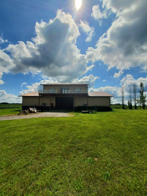 a large building in the middle of a grass field