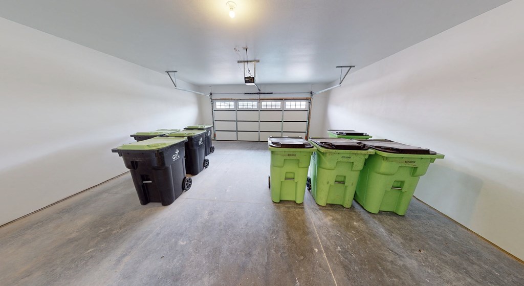 a room with green trash bins in the middle of it