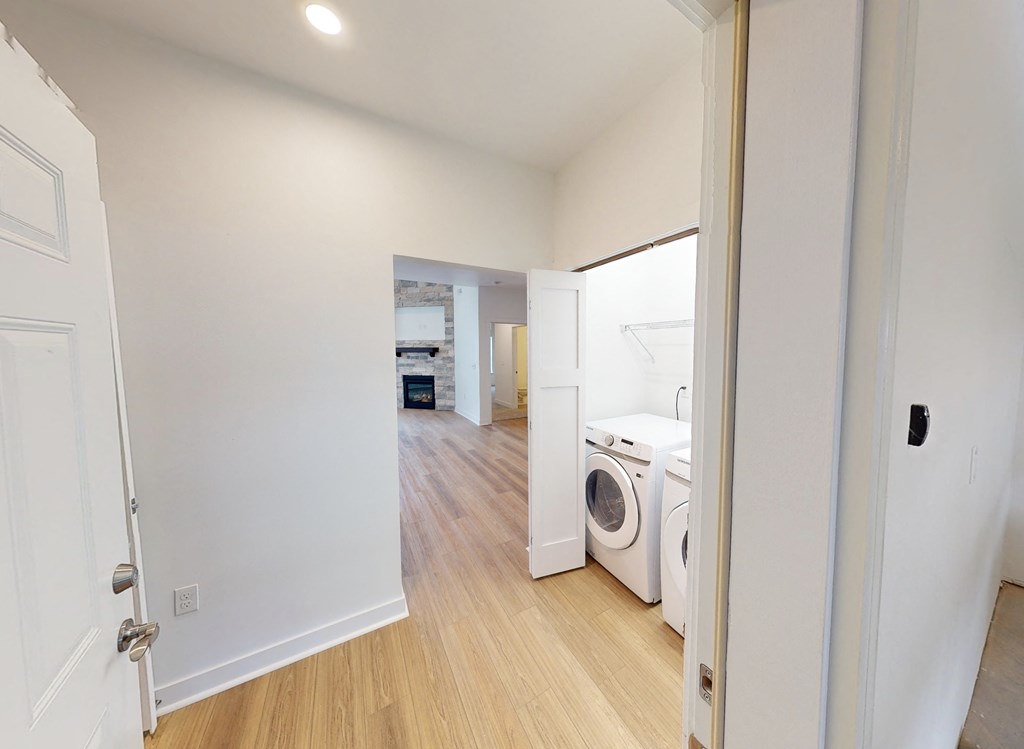 a laundry room with a washer and dryer in a house