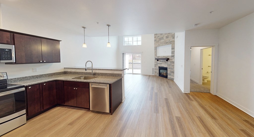 a kitchen and living room with wood flooring and