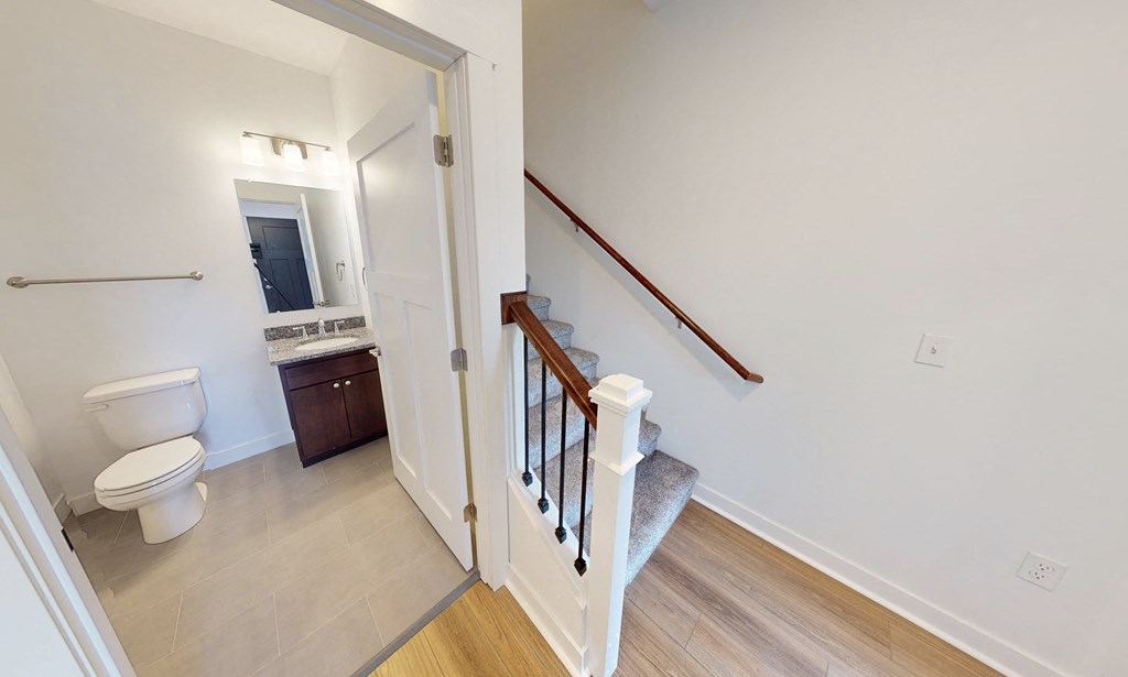 a view of a staircase in a home with a bathroom and a toilet