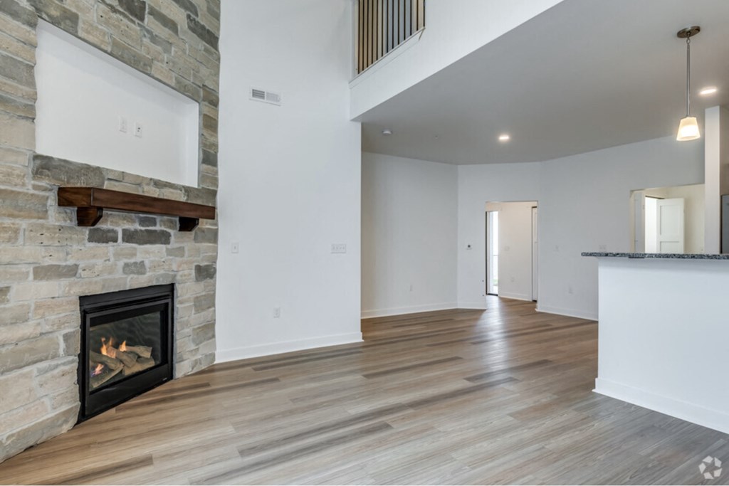 the living room with a fireplace in a new home