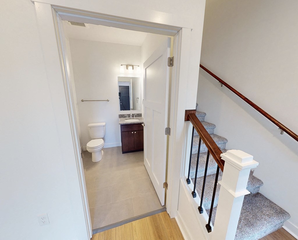 a view of a bathroom from the stairs in a home
