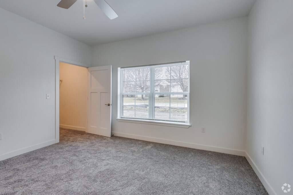 a living room with a large window and a door