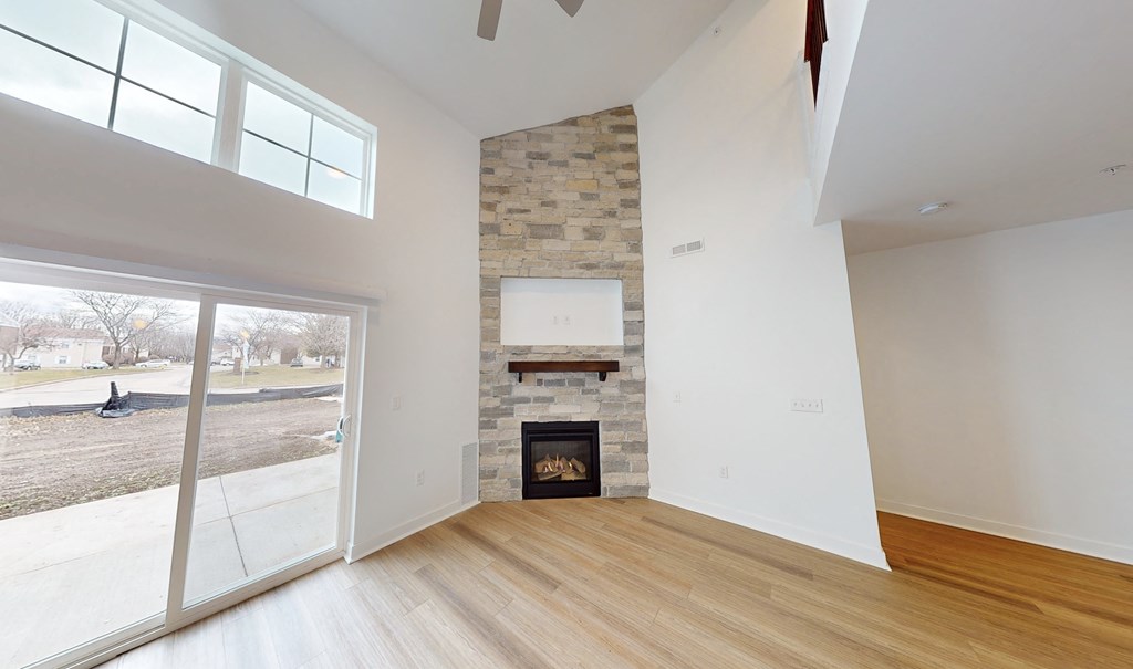 a living room with a fireplace and a sliding glass door