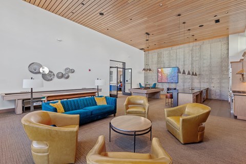 a living room with couches and chairs and a table