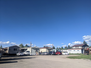 a group of trailers and cars parked in a parking lot