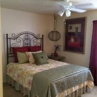 a bedroom with a bed and a ceiling fan