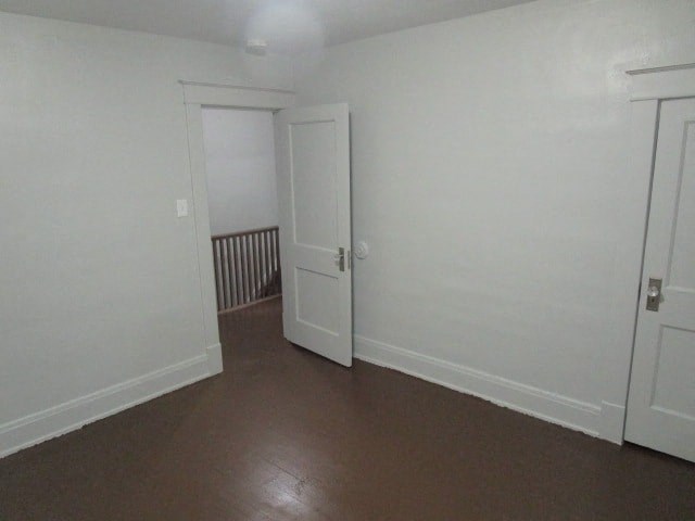 a room with white walls and a door and a hallway