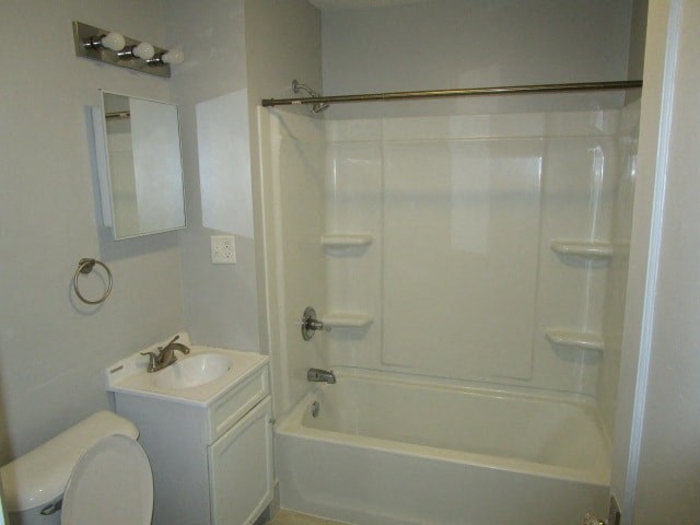 a white bathroom with a sink toilet and a shower