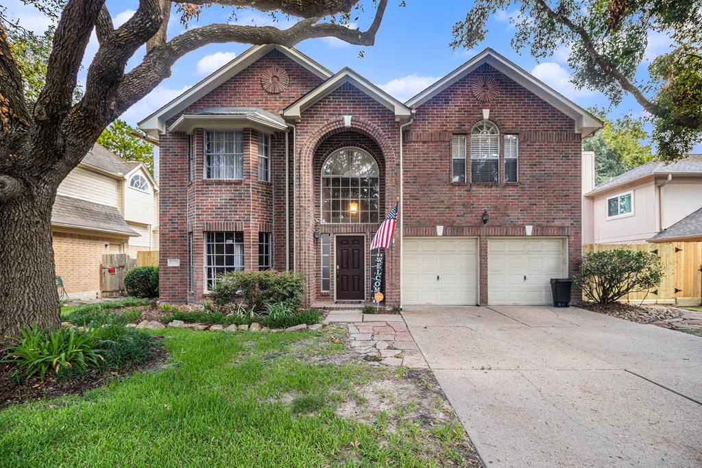 a brick house with an flag on the driveway