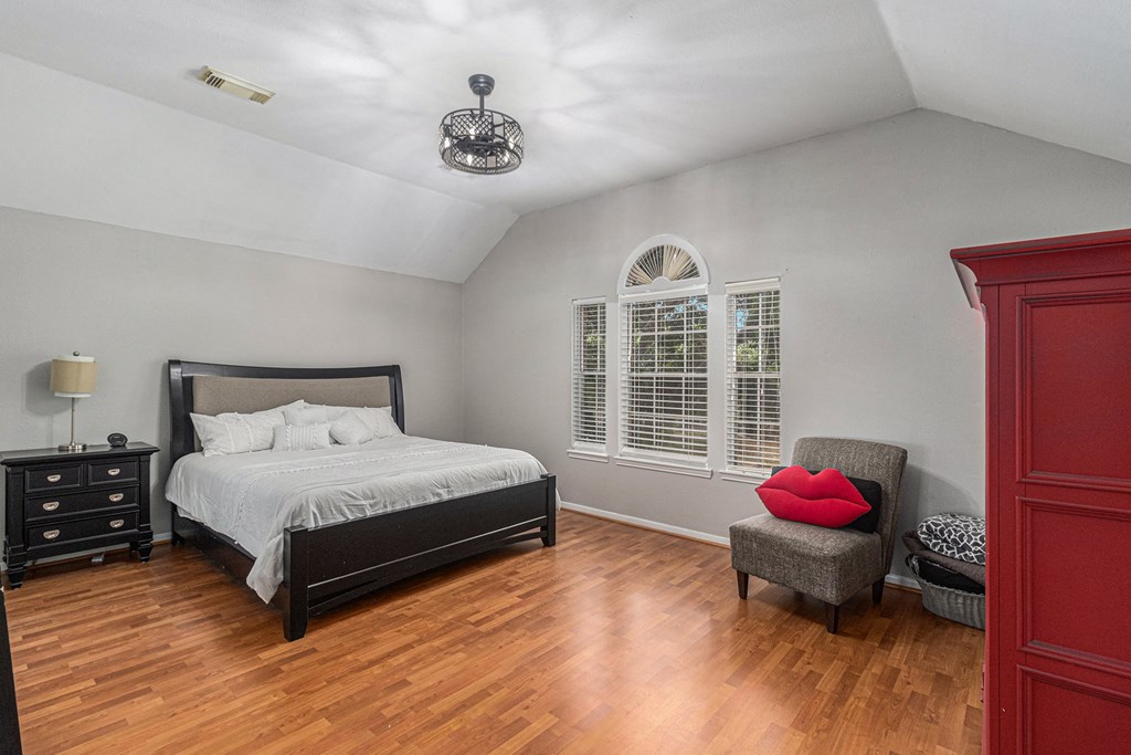 a bedroom with a large bed and a window