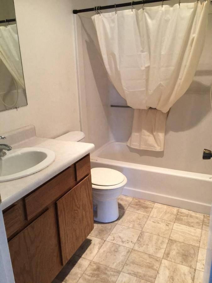 a bathroom with a toilet and a sink and a bath tub