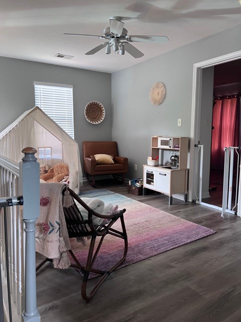 A living room with a rocking chair and a couch.