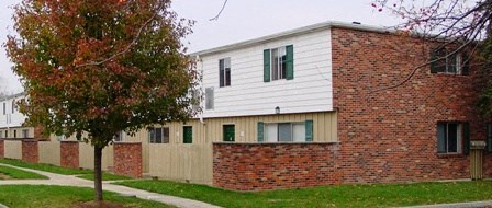 a brick building with a tree in front of it
