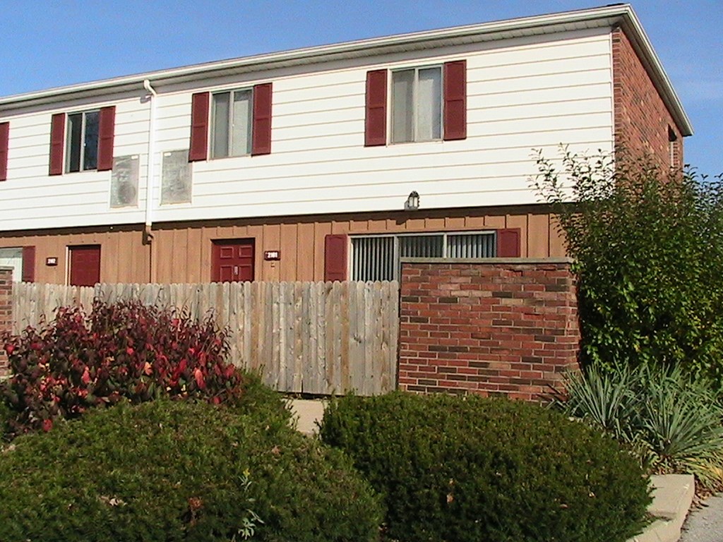 a house with a wooden fence in front of it