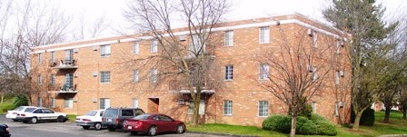 a large brick building with cars parked in front of it