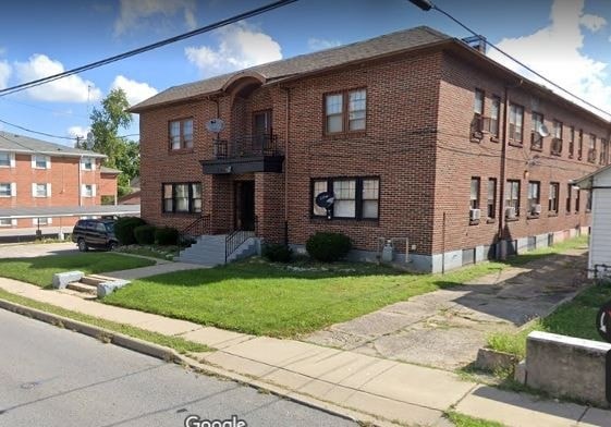 a red brick apartment building on the corner of a street