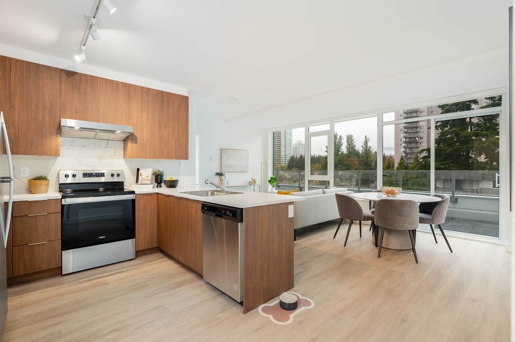 A modern kitchen with a dining table and chairs.