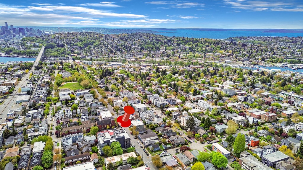 an aerial view of a city with a red figure in the middle