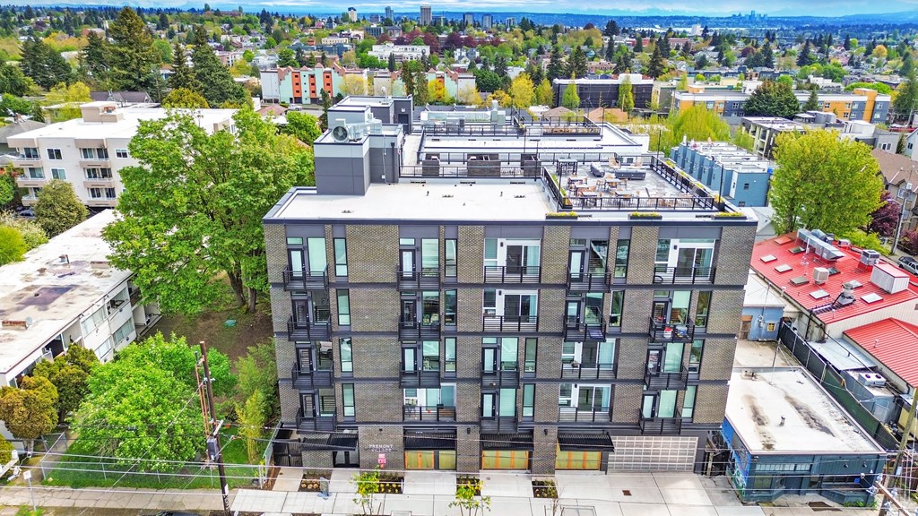 an aerial view of a building with a city in the background