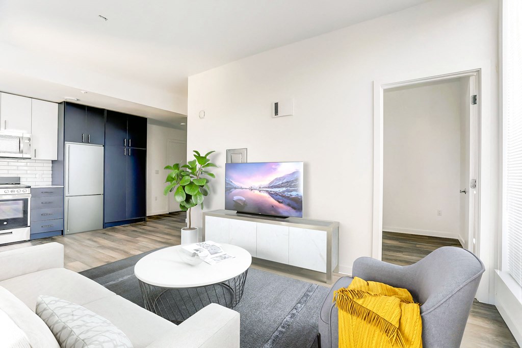 a living room with a white couch and a tv