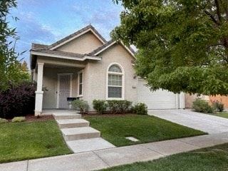 a house with a lawn and sidewalk in front of it