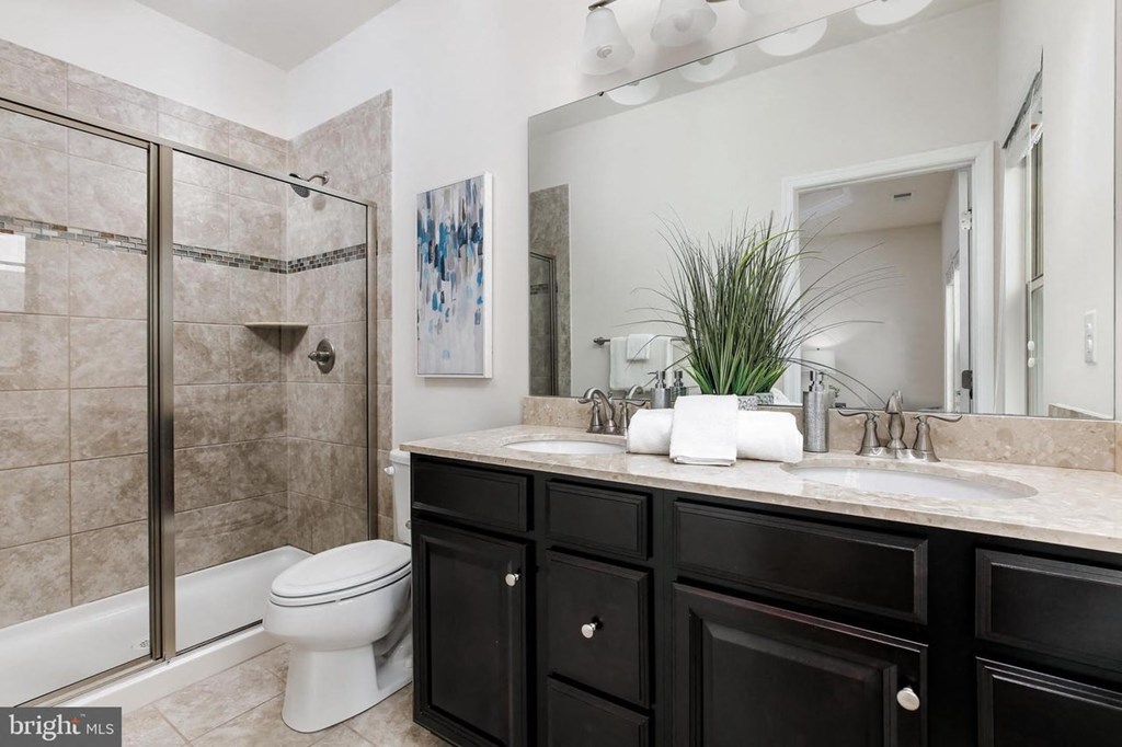 a bathroom with a sink and a toilet and a shower