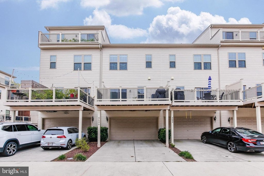 a large white building with cars parked in front of it