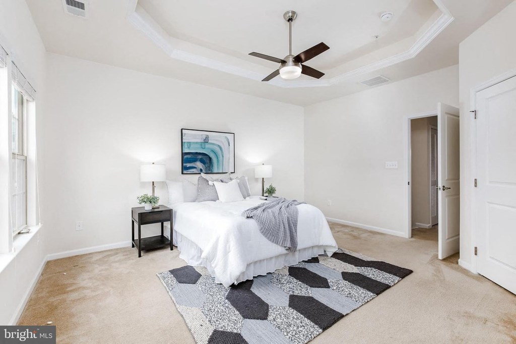 a bedroom with a bed and a ceiling fan