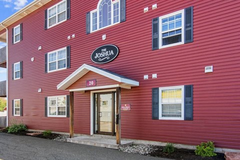 The front of a red building with a sign that says "The Joshua".