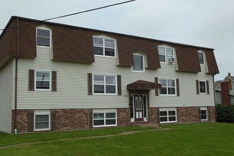 A two-story house with a brown roof and white siding.