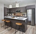 a kitchen with an island and three bar stools