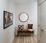 a room with a chair and a mirror on the wall