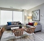 a living room with a couch and a table and chairs