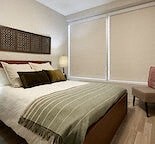 a bedroom with a bed and a large window