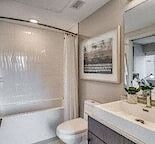 a bathroom with a sink and a toilet and a shower