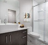 a bathroom with a toilet and a sink and a shower