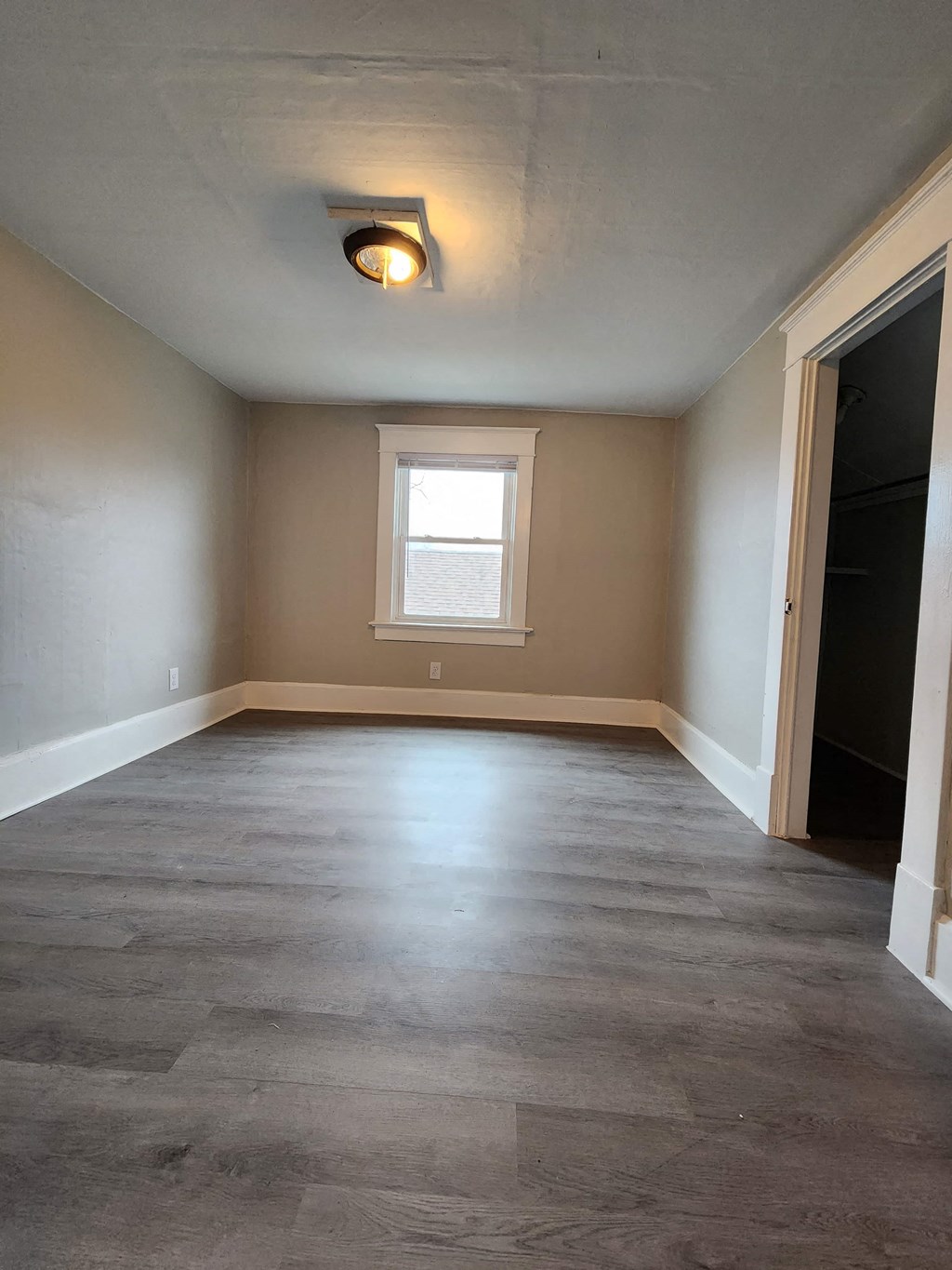 a empty room with a window and a door