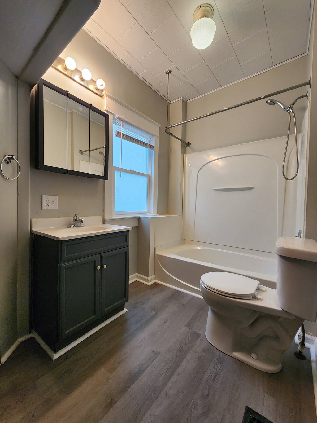 a bathroom with a toilet and a sink and a bath tub