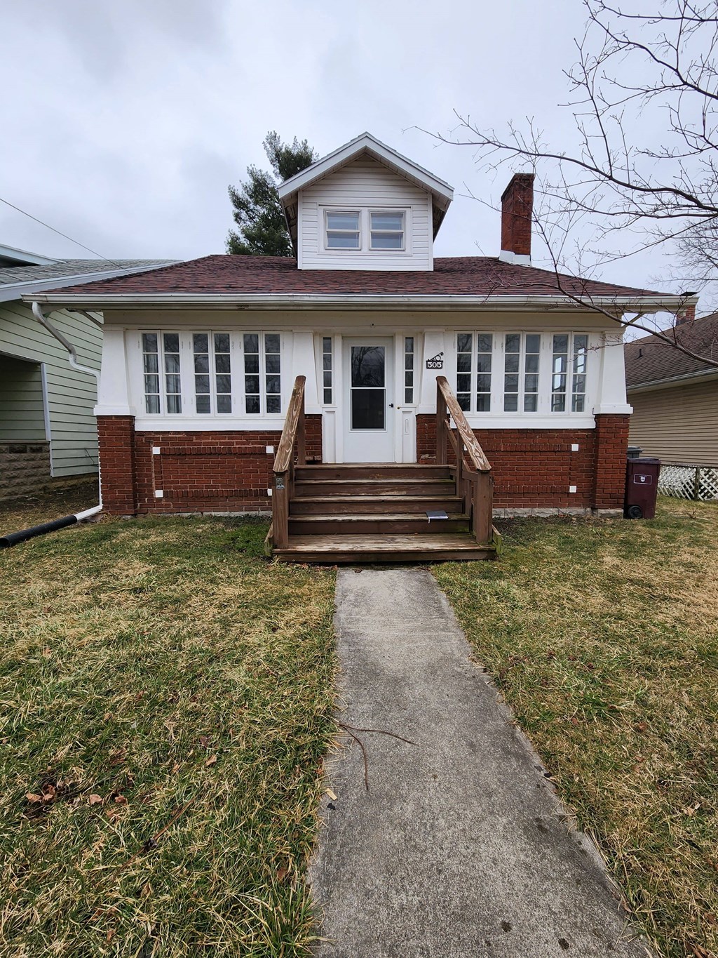 a front view of a house with a porch and a walkway